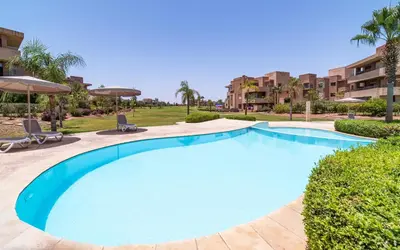 a large blue swimming pool in a resort at Exceptional Style Nonstop Luxury in Marrakech