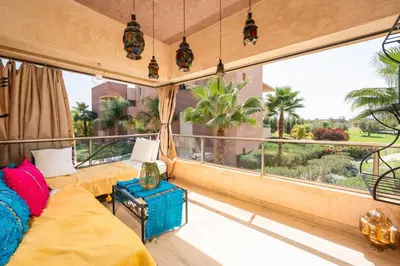 a living room with a couch and a large window at Exceptional Style Nonstop Luxury in Marrakech