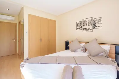 a bedroom with a large white bed with two pillows at Relax Front Of Pool-Garden-Fibre in Marrakech