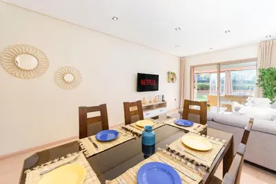 a dining room with a table and chairs and a couch at Relax Front Of Pool-Garden-Fibre in Marrakech