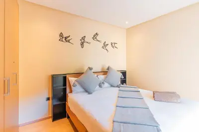 a bedroom with a bed with birds on the wall at Relax Front Of Pool-Garden-Fibre in Marrakech