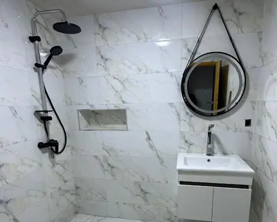 a white bathroom with a sink and a mirror at Comfy family flat 10 mins from Medina in Marrakech
