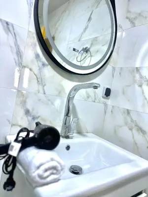 a bathroom with a sink and a mirror at Comfy family flat 10 mins from Medina in Marrakech