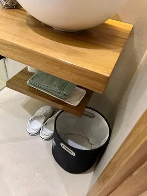 a bowl on top of a wooden table next to a black potasteryasteryastery at Luxe appartement à louer pour les familles in Marrakech