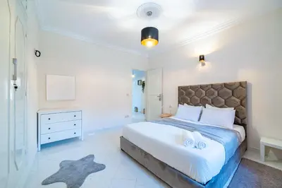 a bedroom with a large bed with two towels on it at Central appartement in the heart of Guéliz in Marrakech