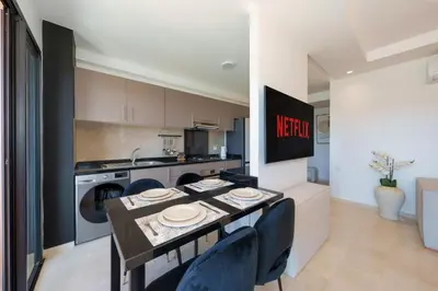 a kitchen with a table with chairs and a counter top at Belle vue, noria golf in Marrakech