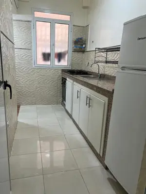 a kitchen with a white refrigerator and a window at Confort Abordable Louez Notre Appartement in Marrakech