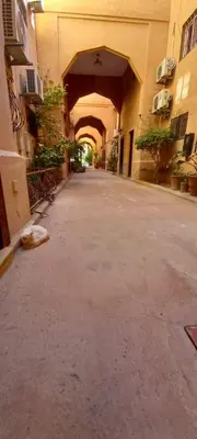 an empty alley with an archway in a building at Riad Nour Resorts in Marrakech