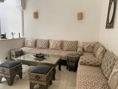 a living room with a couch and a table at Riad Nour Resorts in Marrakech