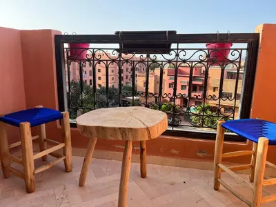 a table and two chairs in front of a window at Appartement Denda in Marrakech