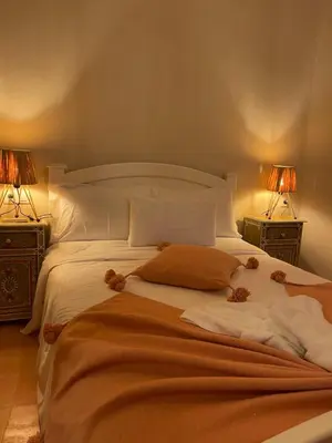 a bed with teddy bears on it with two lamps at Riad212 private medina fast Wi-Fi plunge pool in Marrakech