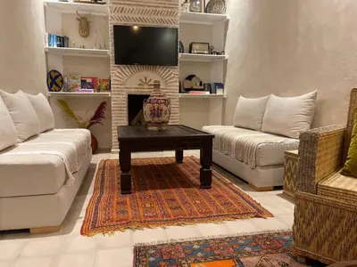a living room with a couch and a fireplace at Riad212 private medina fast Wi-Fi plunge pool in Marrakech