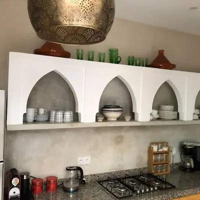 a kitchen with shelves with bowls and plates on it at Riad212 private medina fast Wi-Fi plunge pool in Marrakech