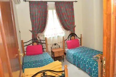 a bedroom with two beds and a window at Cheap accommodation in Marrakech in Marrakech