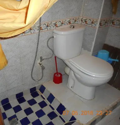 a bathroom with a toilet with a hose at Cheap accommodation in Marrakech in Marrakech