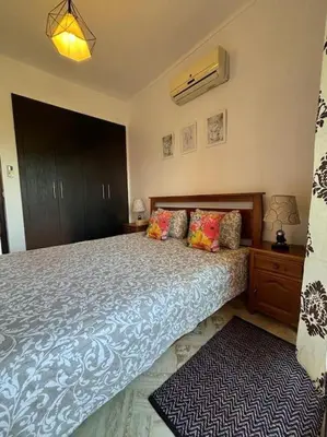 a bedroom with a large bed with a blue comforter at Cozy apartment with roof top in Marrakech