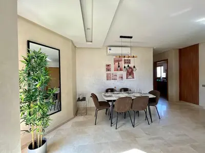 a dining room with a table and chairs at New appart, pool and golf view in Marrakech