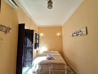 a small bedroom with two beds in a room at Dar Mirai in Marrakech