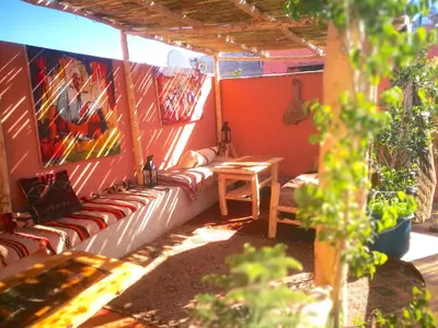 a porch with couches and paintings on the wall at Dar Mirai in Marrakech