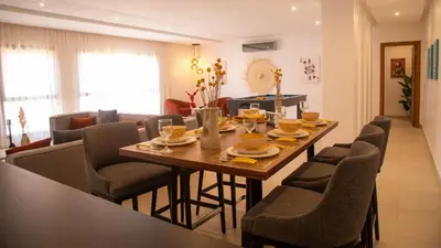 a dining room and living room with a table and chairs at Loft Atlas in Marrakech