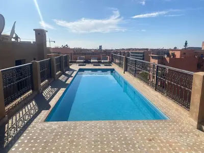 a swimming pool on the roof of a building at Appart de standing + piscine sur le toit in Marrakech
