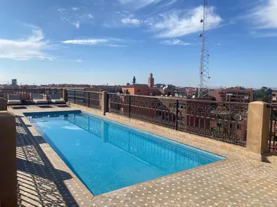 a swimming pool on the roof of a building at Appart de standing + piscine sur le toit in Marrakech