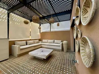 a living room with a couch and a coffee table at Appart de standing + piscine sur le toit in Marrakech