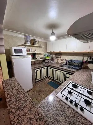 a kitchen with a white refrigerator and a stove at Riad Paolo Piscine Palmeraie in Marrakech