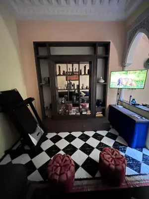 a living room with a checkered floor and a mirror at Riad Paolo Piscine Palmeraie in Marrakech