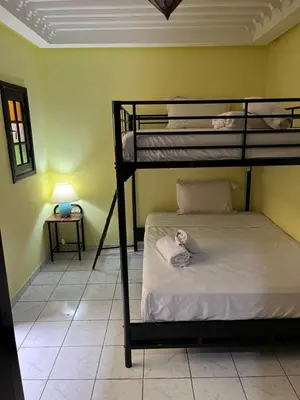 a bedroom with two bunk beds in a room at Riad Paolo Piscine Palmeraie in Marrakech
