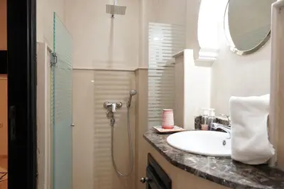 a bathroom with a sink and a shower at Riad Roummana Marrakech in Marrakech