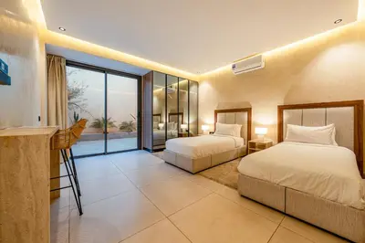 a hotel room with two beds and a balcony at Villa Tolède by TheCasaEdition in Marrakech