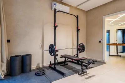 a gym with a bench in a room at Villa Tolède by TheCasaEdition in Marrakech