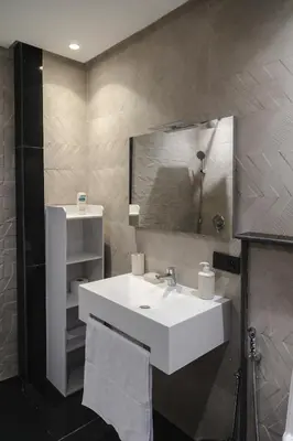 a bathroom with a white sink and a mirror at Appartement Uniquement Familial 2 Chambres spacieux cosy, calme in Marrakech