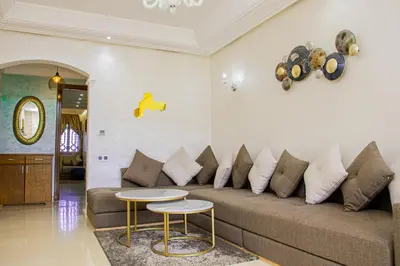 a living room with a couch and two tables at Tibouda House Deluxe Avec Piscine - Familiale in Marrakech
