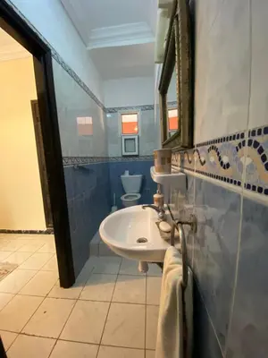 a bathroom with a sink and a mirror and a toilet at Riad Ayiss piscine palmeraie in Marrakech