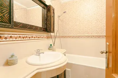 a bathroom with a sink and a bath tub at Modern Odyssey – Marrakech Centre in Marrakech