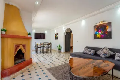 a living room with a couch and a fireplace at Villa privée avec piscine Sans vis-à-vis, calme absolu in Marrakech
