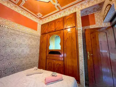 a bedroom with a bed with two towels on it at Dar Amane - Charmante maison marocaine in Marrakech