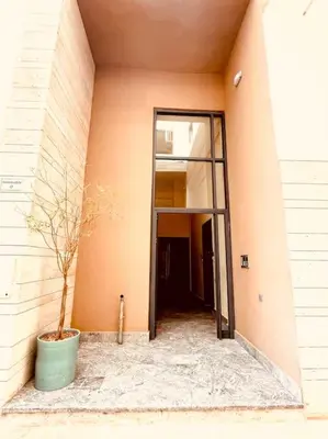 a plant in a pot in the corner of a building at Menara Garden pool in Marrakech