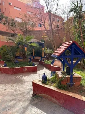 a park with a gazebo and a fire hydrant at Charmant appartement avec piscine 2chambres au cœur de Guéliz in Marrakech