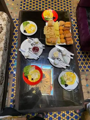 a tray of food with plates of food on a table at Riad Jennah Rouge in Marrakech