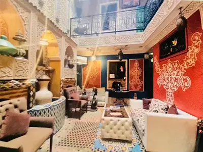 a room with chairs and tables in a room with at Riad Jennah Rouge in Marrakech