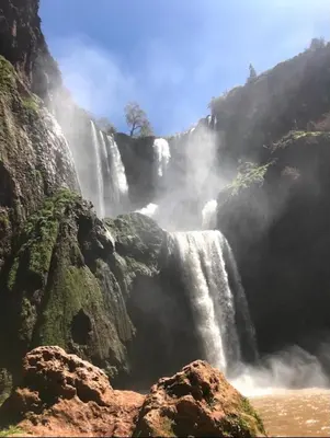 a waterfall on a mountain with aploadploadploadploadploadploadploadploadpload at Riad Jennah Rouge in Marrakech