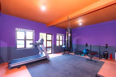 a gym with purple walls and a gym with a treadmill at Palais Sena in Marrakech