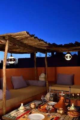 a living room with a couch and a table at Riad L'Aziza in Marrakech