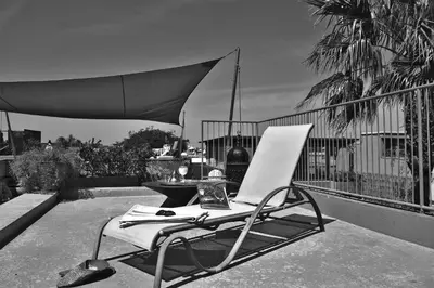a white chair sitting on top of a balcony at Riad L'Aziza in Marrakech