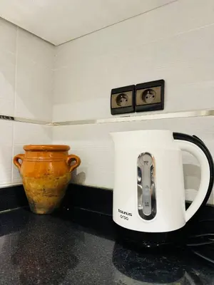 a toaster sitting on a counter next to a vase at Jardin Yves Appartement 2 Chambres Chic in Marrakech