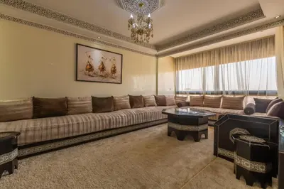 a large living room with a couch and a table at Appartement Raffiné au Centre in Marrakech