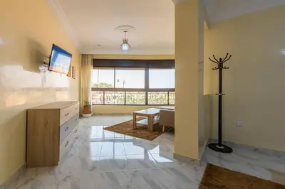a large living room with a desk and a table at Appartement Unique au Centre in Marrakech